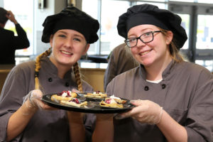 Students Haley Smalley (WEHS) and Meredith Wright (WHS) serve up some tasty treats at the grand opening of Cafe 544 Sept.21.