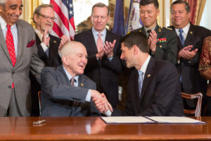 U.S. Rep. Sam Johnson, left, receives congratulations from Speaker of the House Paul Ryan for his work on a bill to add a Wall of Remembrance to the Korean War Memorial.